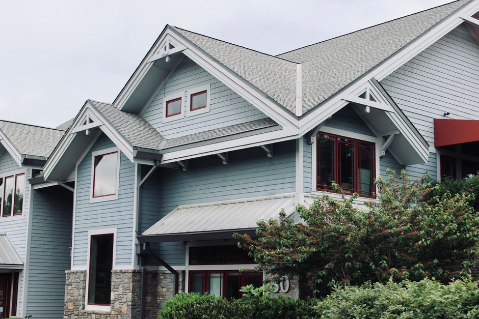 Charming blue house exterior with modern architectural features in Asheville, NC.